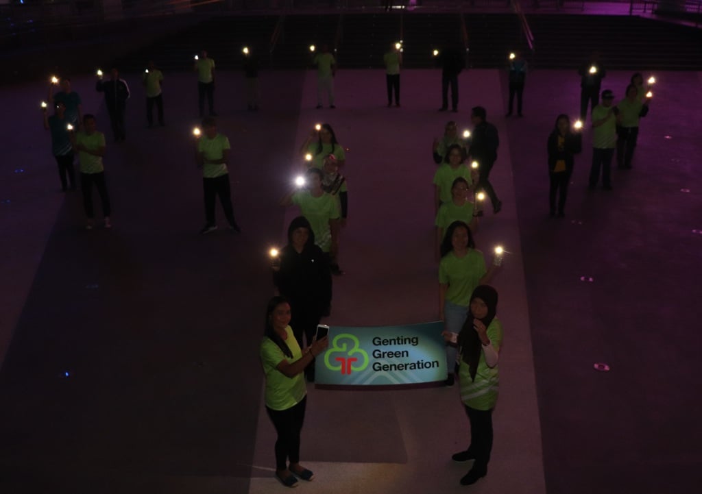 The G3 Volunteers standing in the shape of a tree in support of Earth Hour 2019
